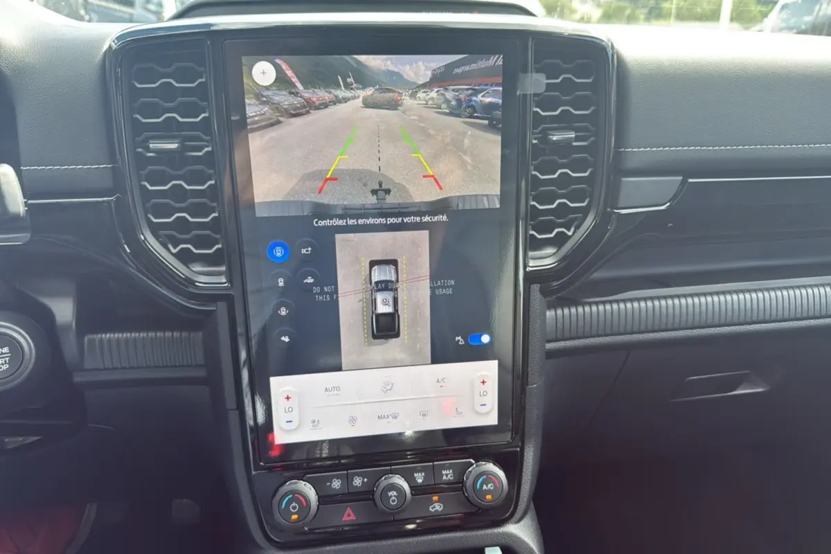 Intérieur du Ford Ranger 2025 noir agate, vue sur l'écran tactile central avec caméra de recul et commandes climatisation.