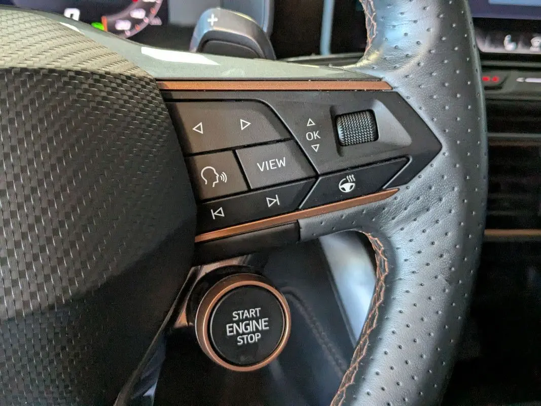 Gros plan sur le volant perforé noir du Cupra Formentor 2025 avec commandes multifonctions et bouton start/stop.