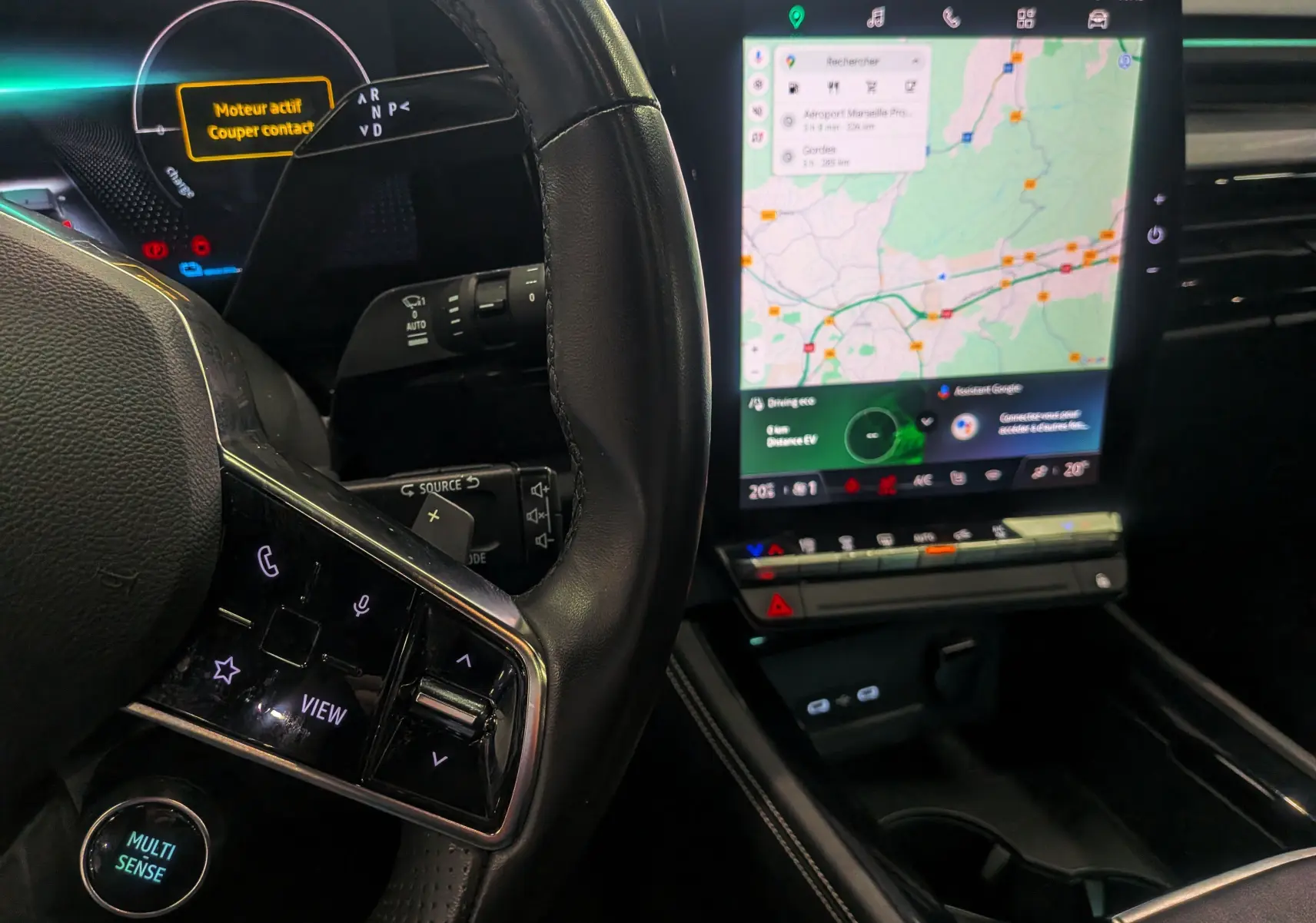 Intérieur du Renault Austral E-TECH 2024, vue sur le volant noir et l'écran tactile central affichant la navigation.