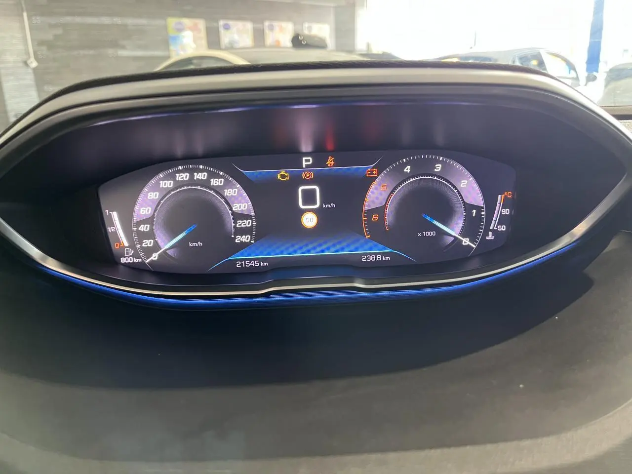 Vue rapprochée du combiné numérique du Peugeot 5008 2024, affichage digital avec éclairage bleu subtil.
