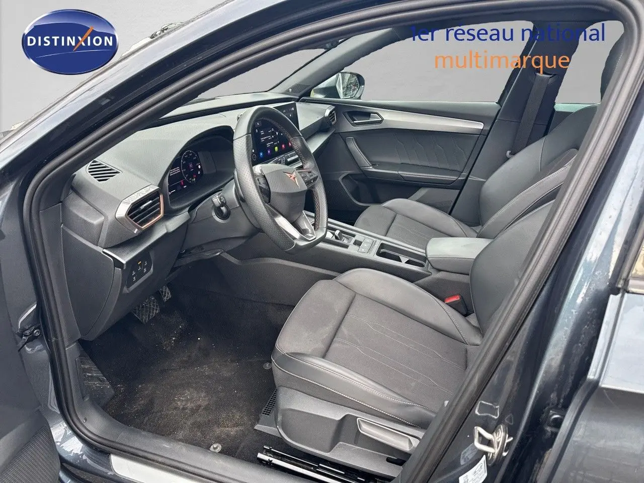 Intérieur avant droit de la CUPRA LEON ST 2024 en gris Magnetic Metal avec sièges en cuir noir et tableau de bord moderne.