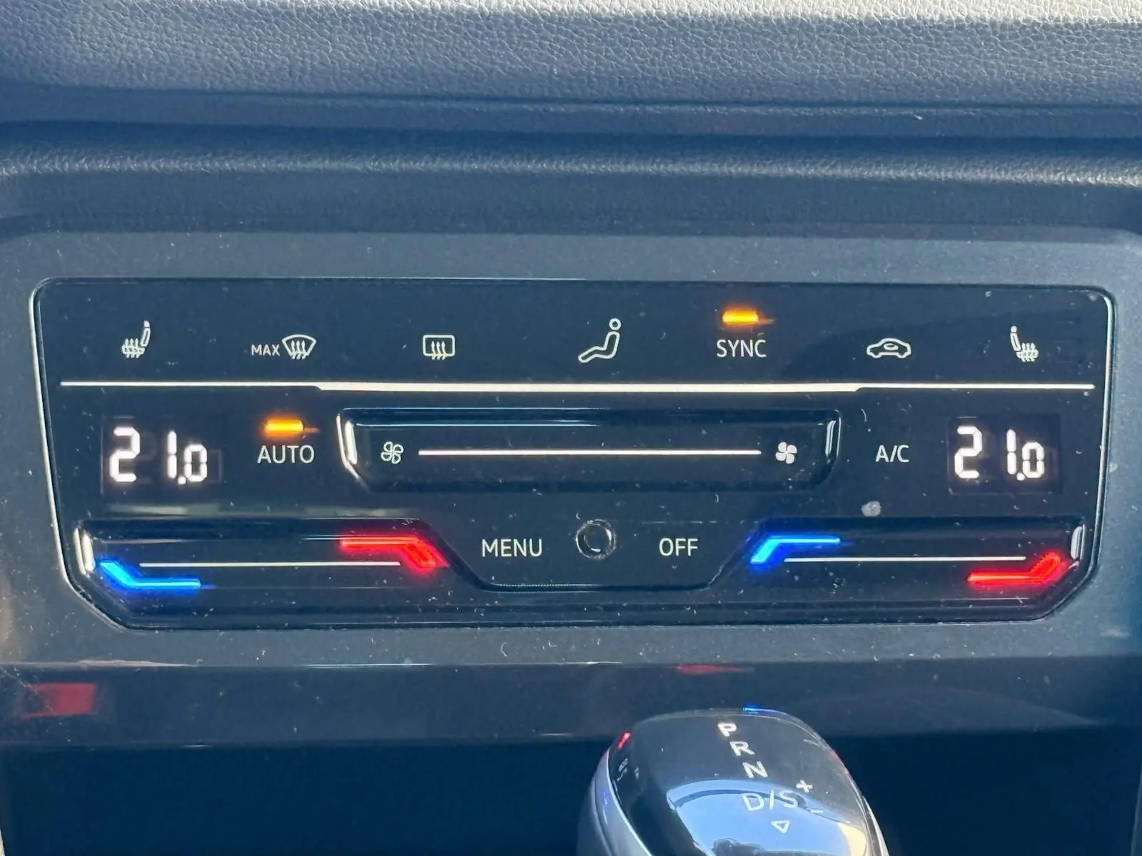 Panneau de commande de la climatisation automatique du Volkswagen Tiguan 1.5 TSI 150CH LIFE DSG7, affichant 21°C et fonctions activées.