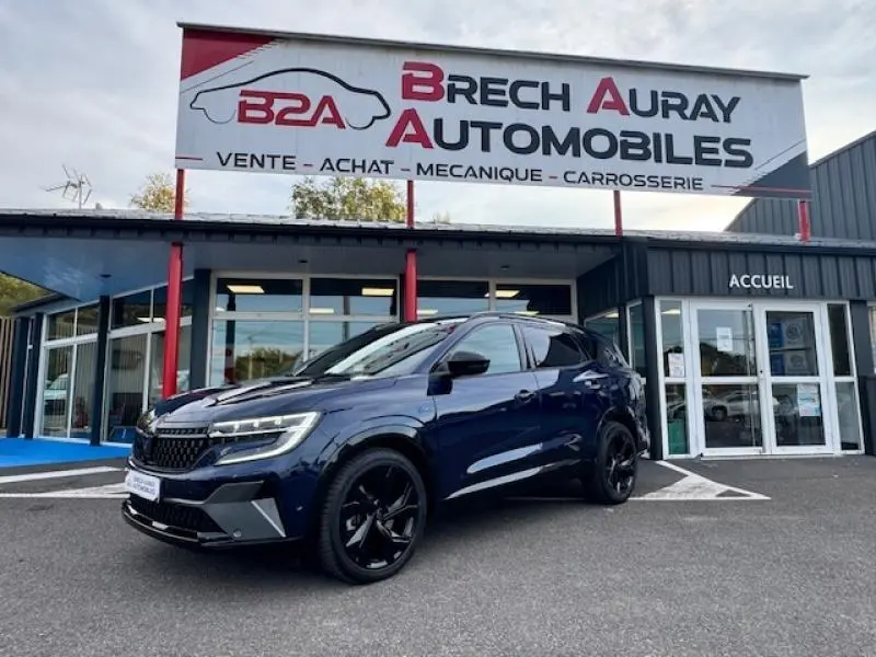 Renault Espace 2023 Bleu Nocturne en 3/4 avant droit, avec jantes noires et feux LED devant un garage Brech Auray Automobiles.