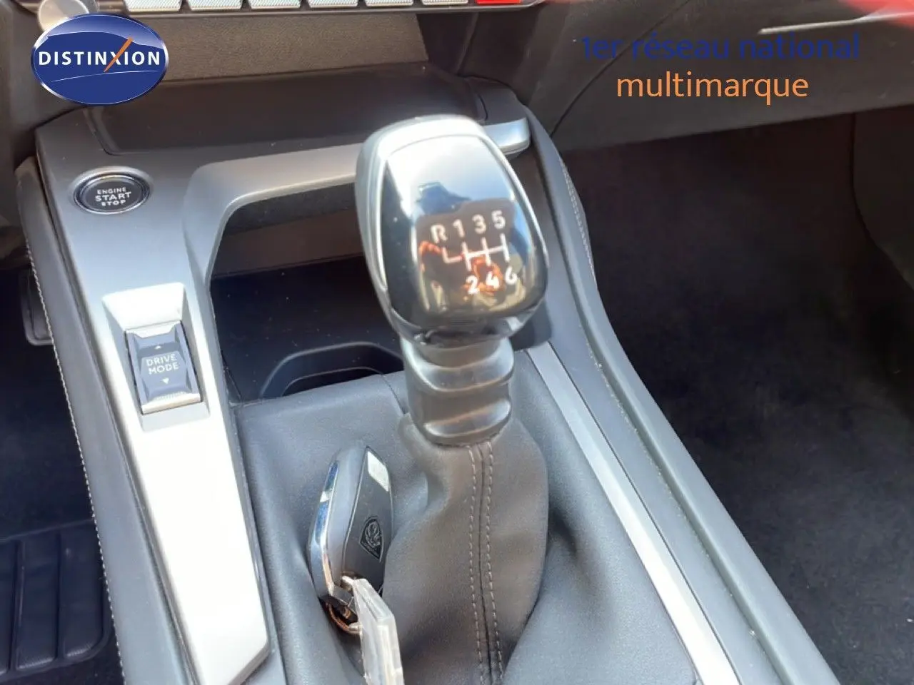 Gros plan sur le levier de vitesses manuel de la Peugeot 308 2024 avec bouton start/stop et commande Drive Mode.