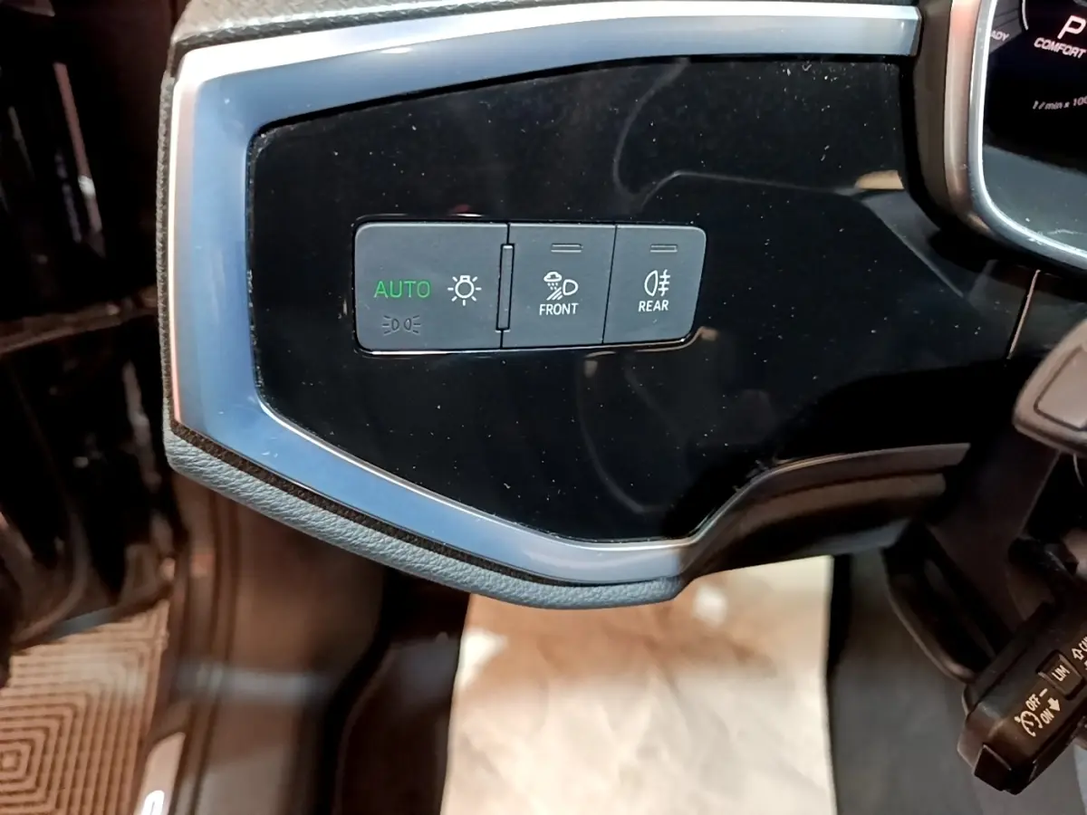 Détail du tableau de bord côté gauche avec commandes d’éclairage sur Audi Q3 gris foncé 35 TFSI 2022.