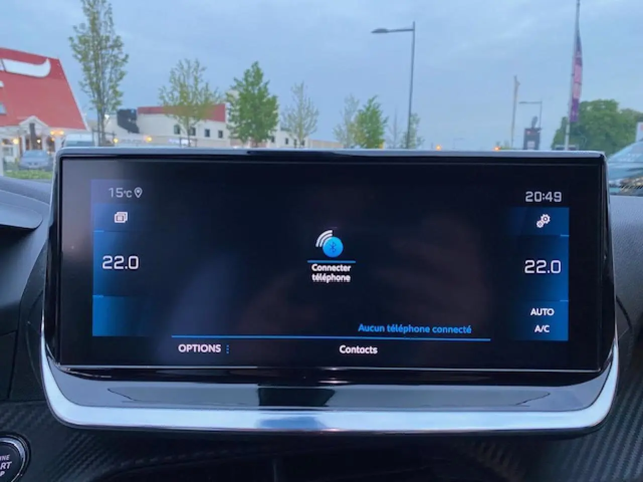 Écran tactile central du Peugeot 2008 blanc 2020 affichant la connexion Bluetooth et la température intérieure à 22°C.