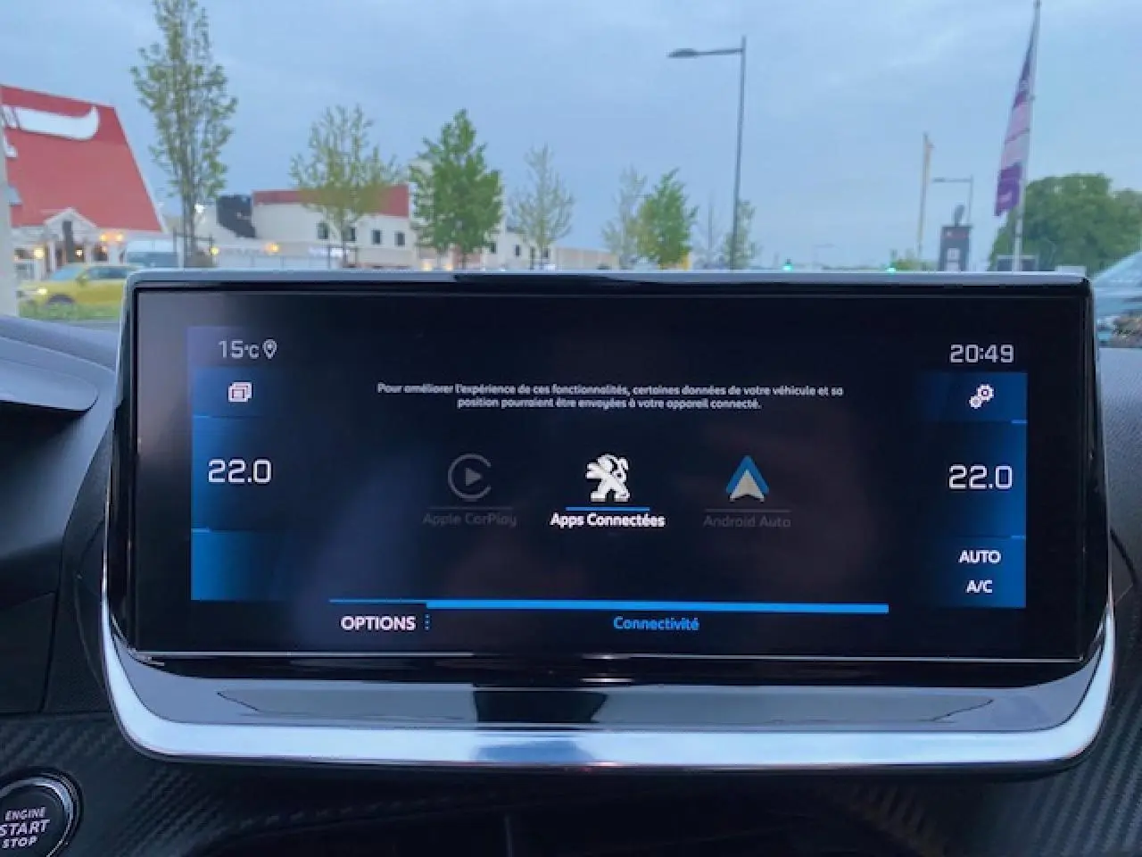 Écran tactile central du tableau de bord du Peugeot 2008 blanc, affichant la connectivité Apple CarPlay et Android Auto.