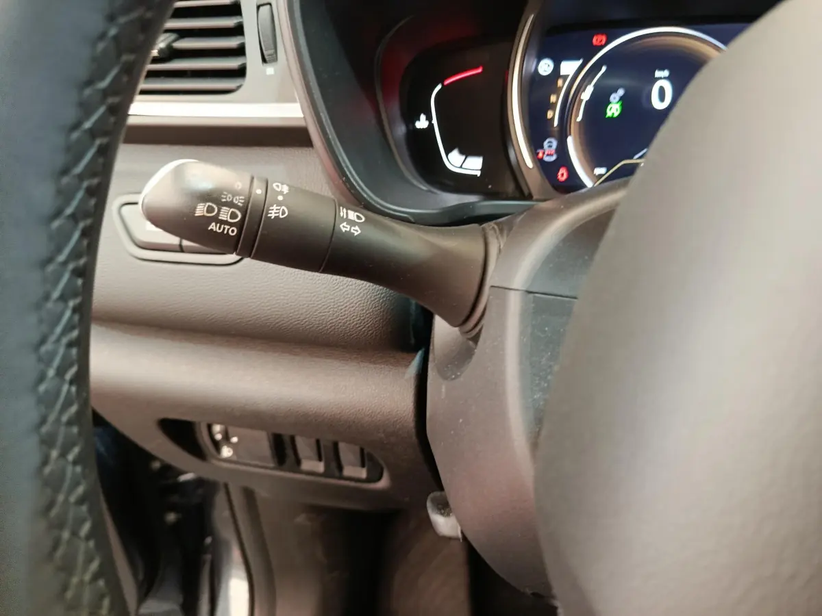 Gros plan sur la manette de phares et clignotants à gauche du volant du Renault Kadjar Business gris foncé 2022.
