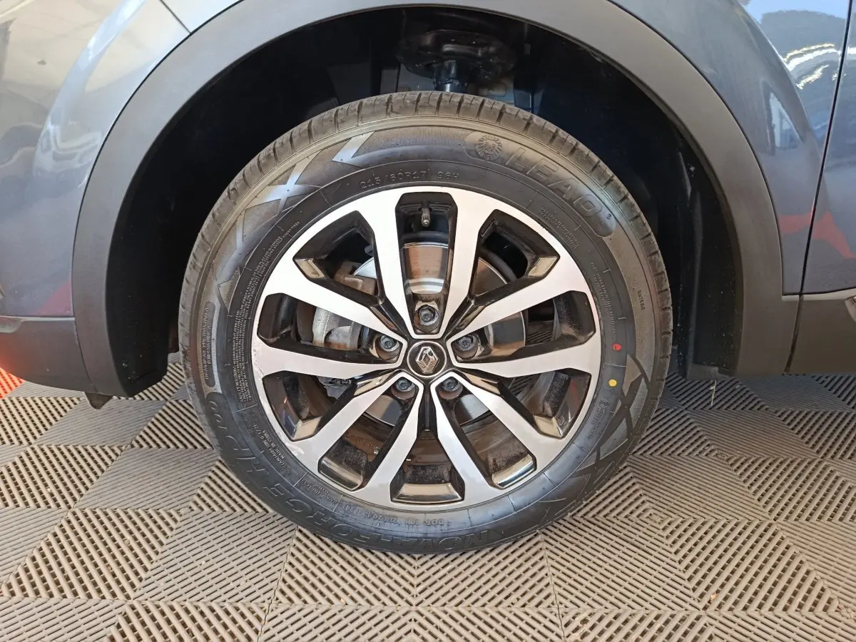 Gros plan sur la roue avant droite du Renault Kadjar gris foncé, mettant en valeur la jante alliage au design moderne.