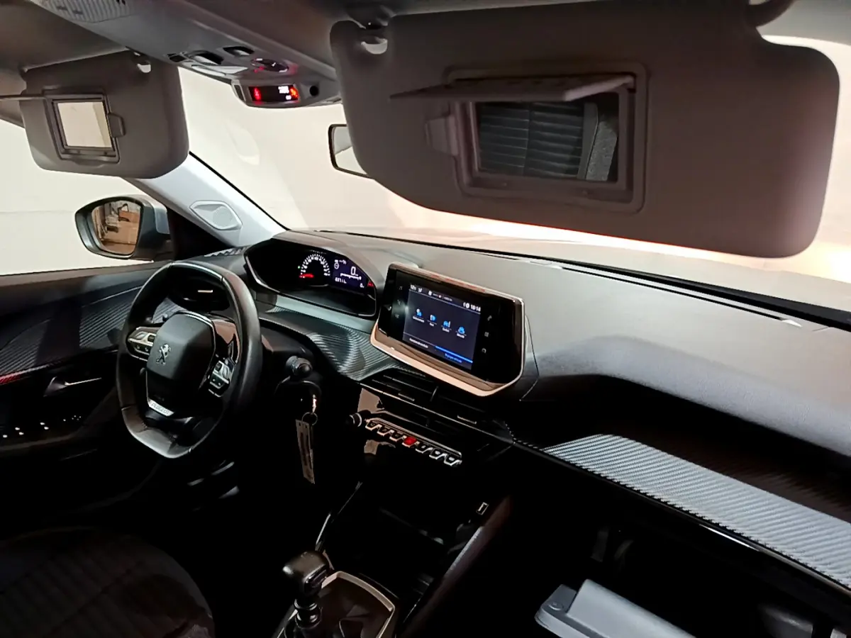 Intérieur Peugeot 2008 BlueHDi 110 vue côté conducteur, tableau de bord moderne avec écran tactile et volant cuir.