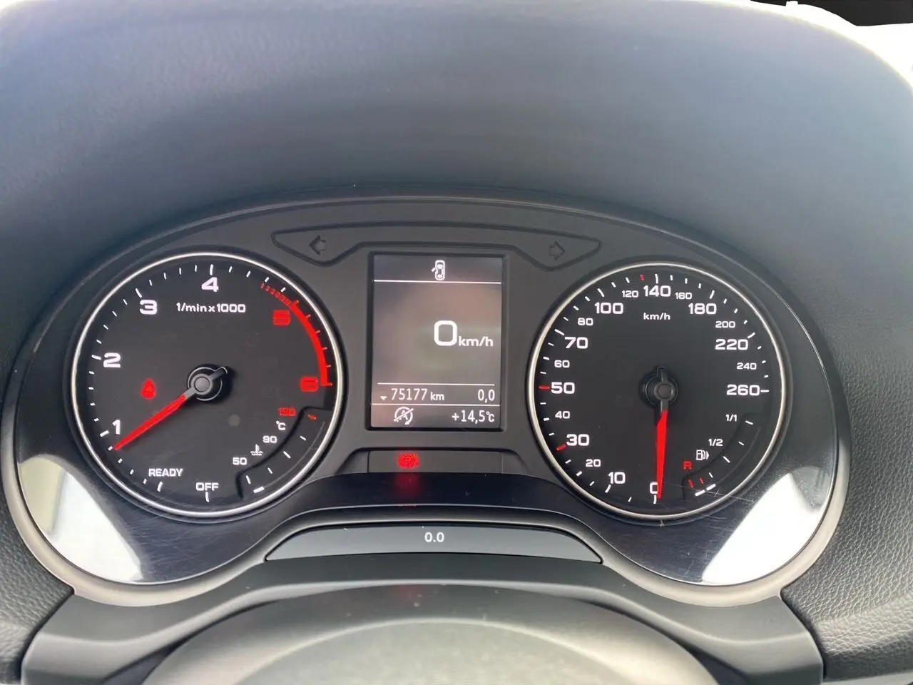 Vue rapprochée du tableau de bord de l'Audi Q2 blanc 2019, affichant le compteur et l'odomètre à 75177 km.