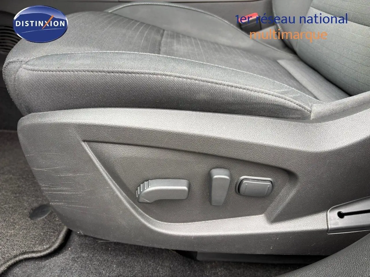 Détail des commandes de réglage électrique du siège conducteur en tissu gris du Renault Arkana noir métal 2022.