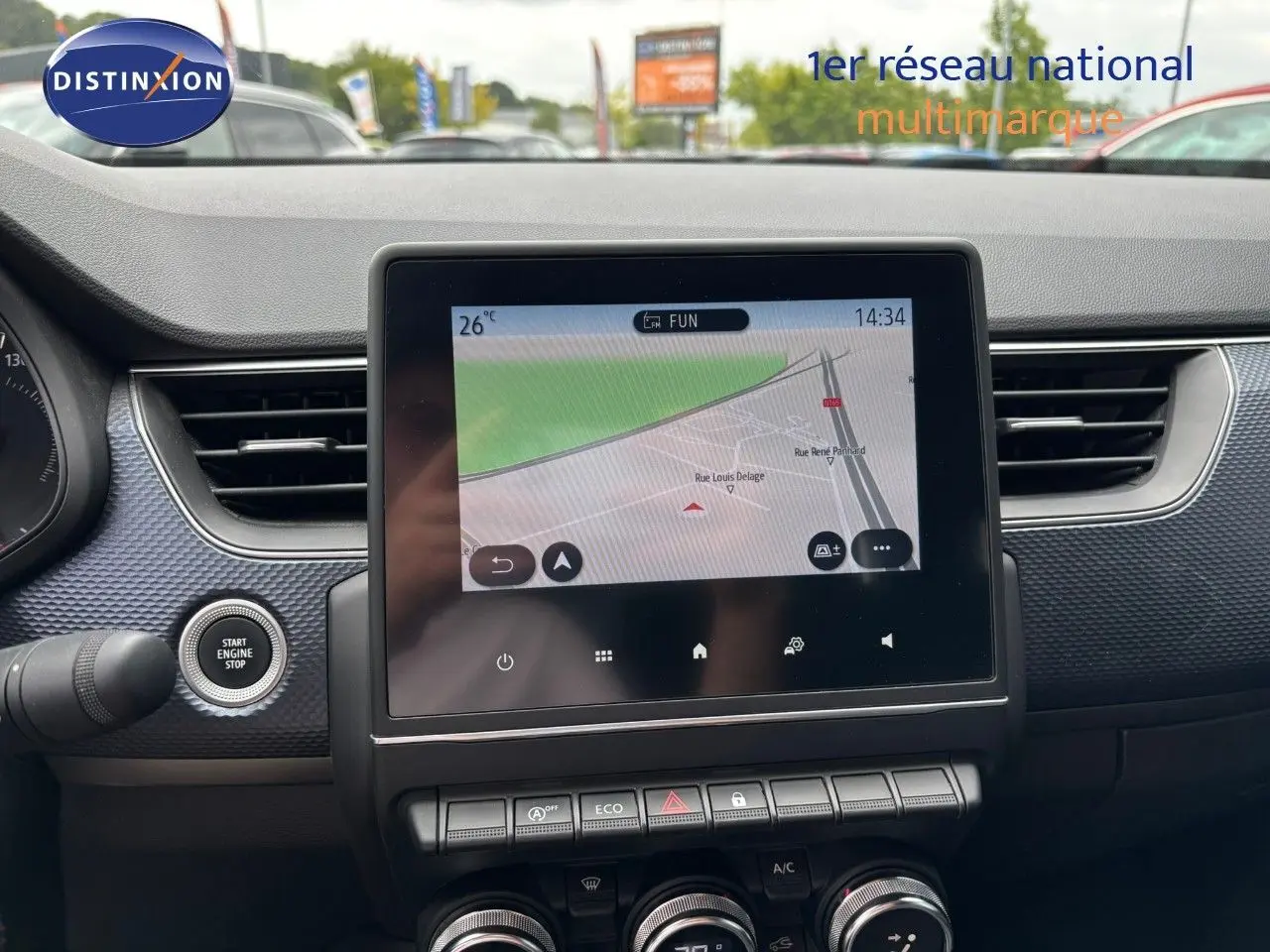 Vue intérieure du tableau de bord du Renault Arkana 2022 avec écran tactile central affichant la navigation et bouton start/stop.