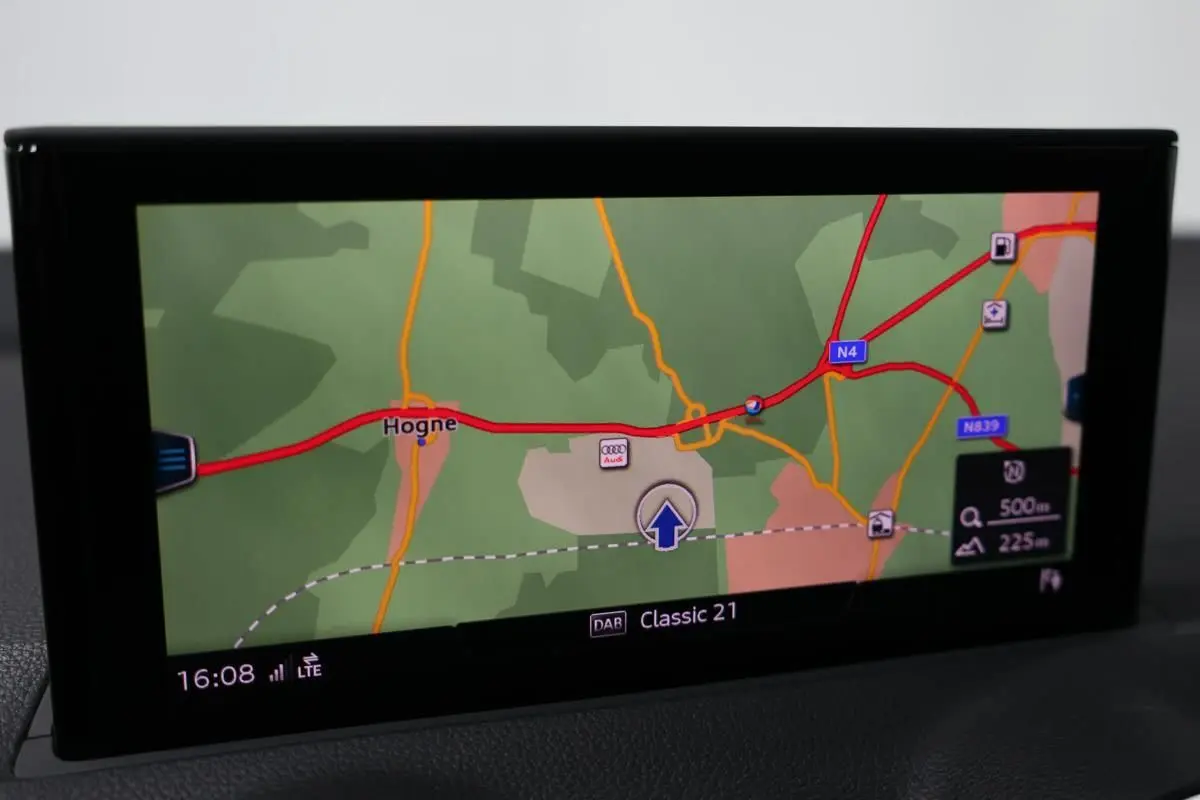 Écran GPS de l'Audi Q2 gris 2023 affichant une carte routière avec itinéraire et indications de distance.