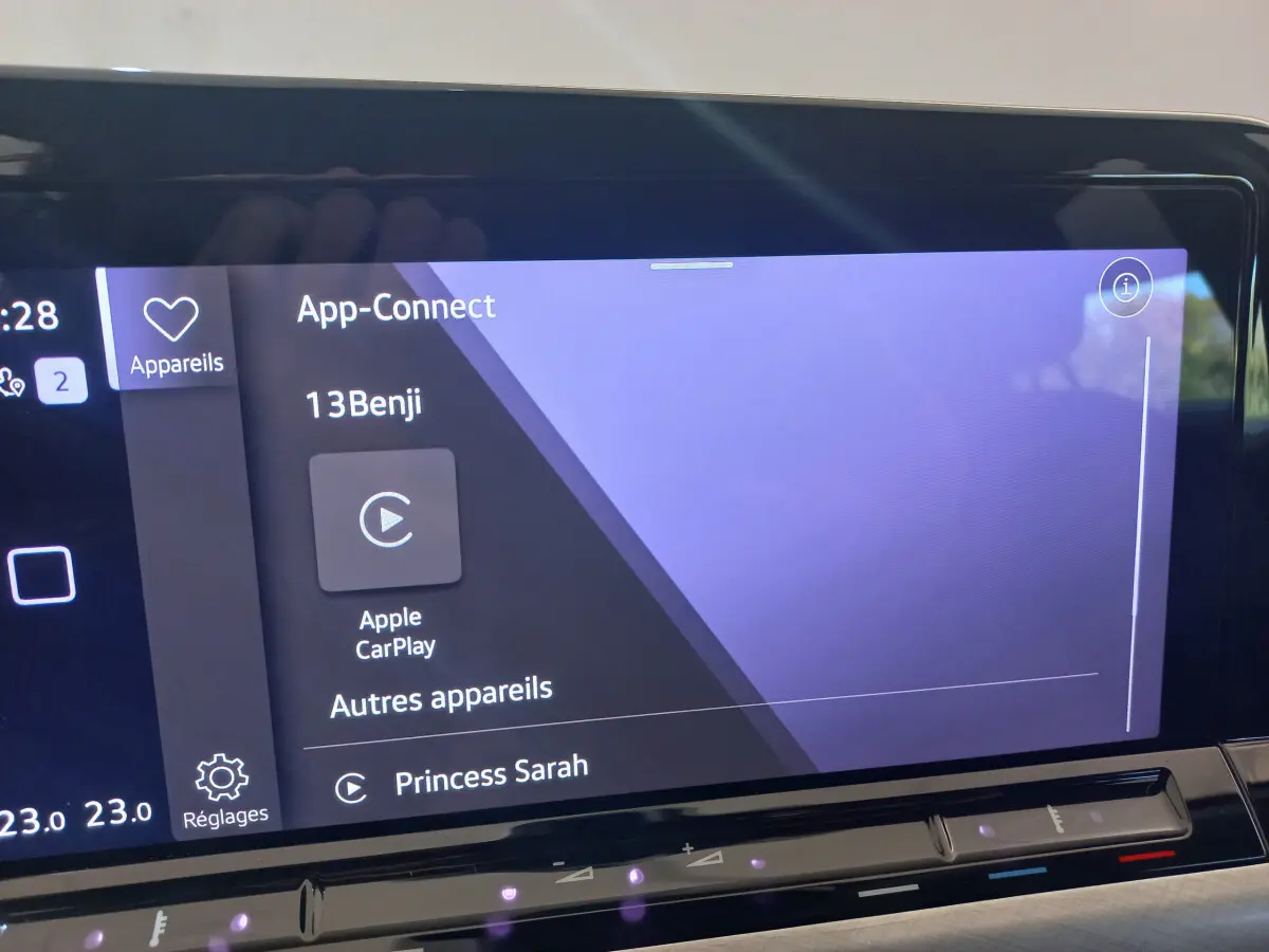 Écran tactile central de la Volkswagen Golf bleu 2022 affichant Apple CarPlay et options connectées.