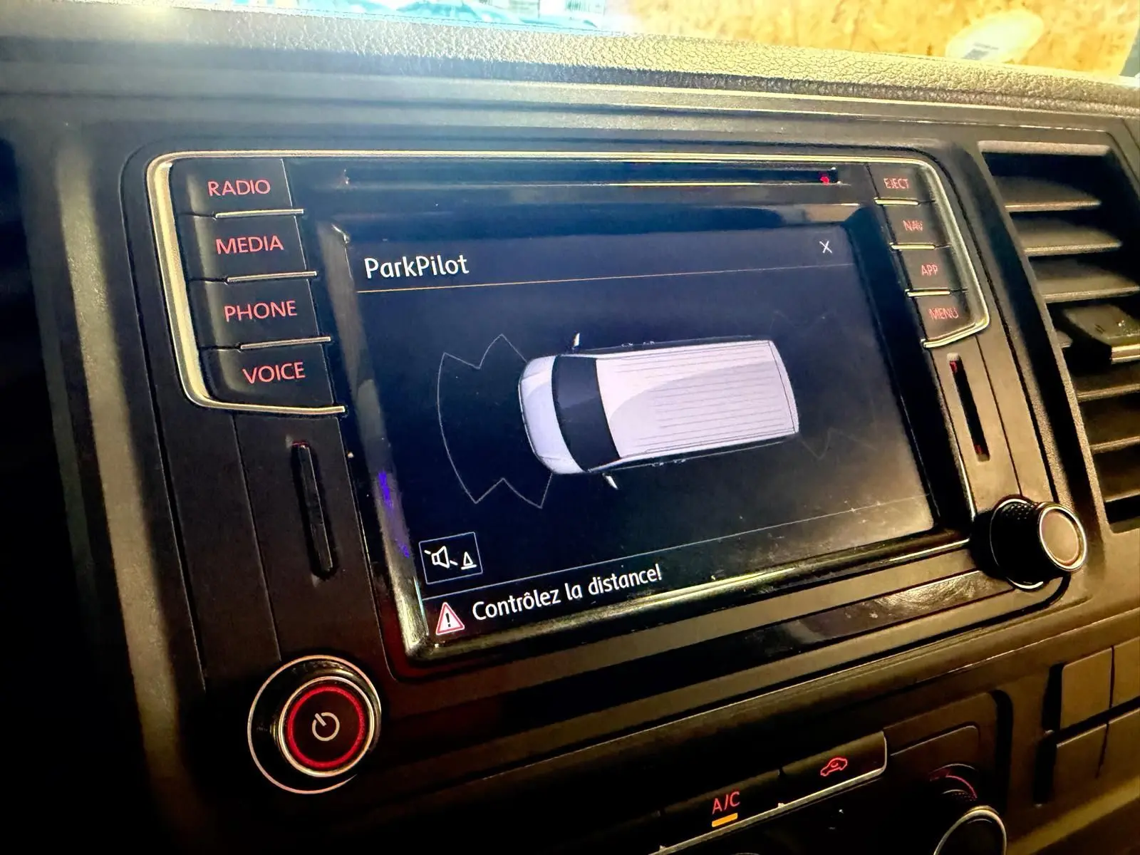 Vue rapprochée de l’écran central du Volkswagen Transporter blanc 2019 affichant l’interface ParkPilot.