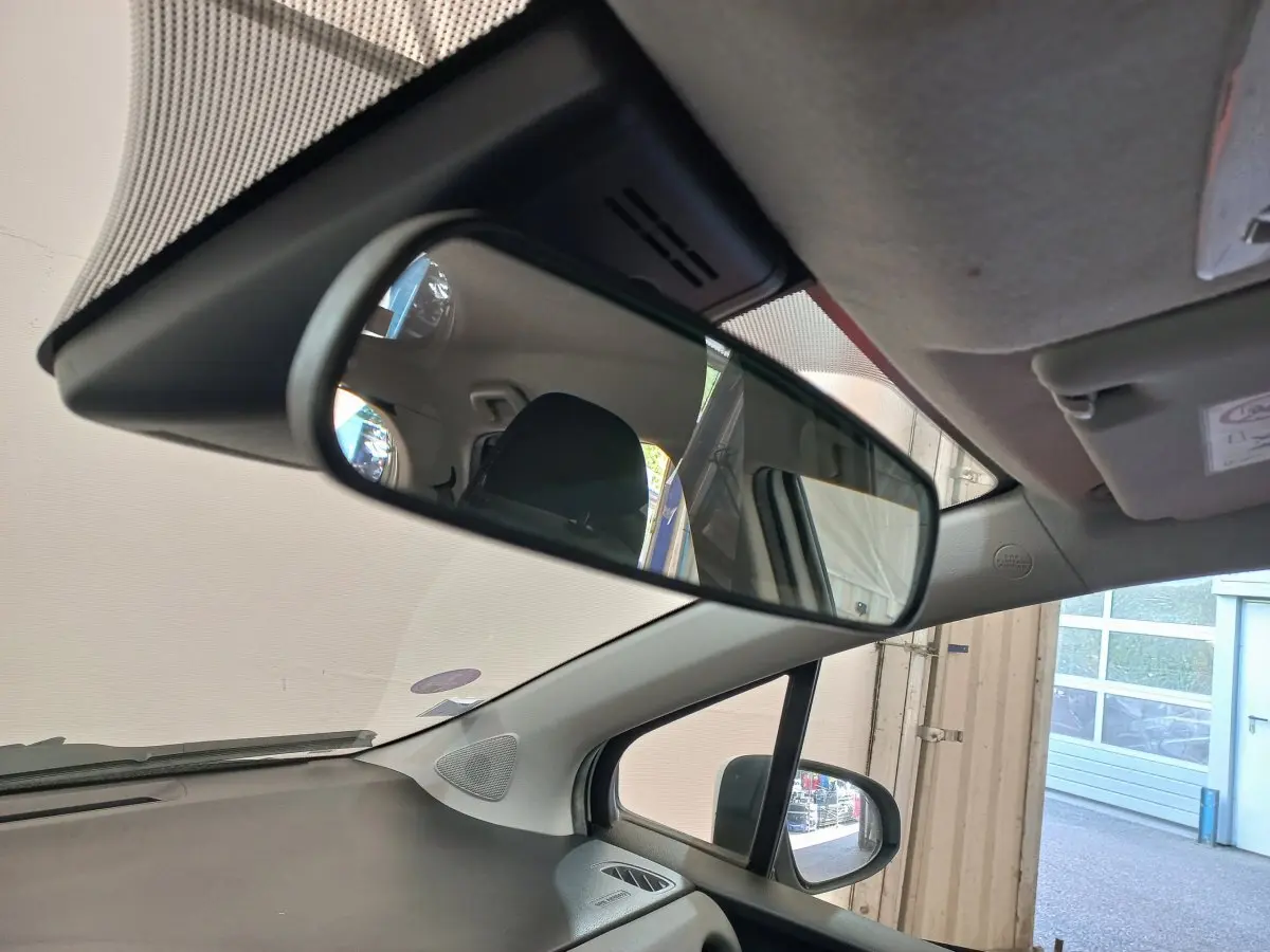 Vue intérieure de la Toyota Yaris blanche 2019, focus sur le rétroviseur central et la partie avant droite.