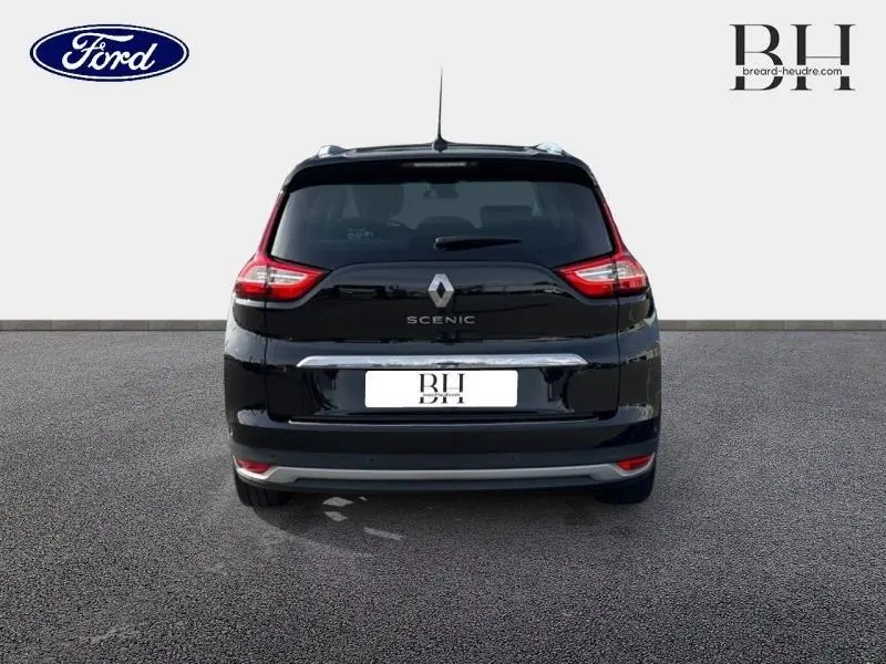 Vue arrière d'un Renault Grand Scenic noir étoilé avec feux arrière LED et barres de toit visibles.