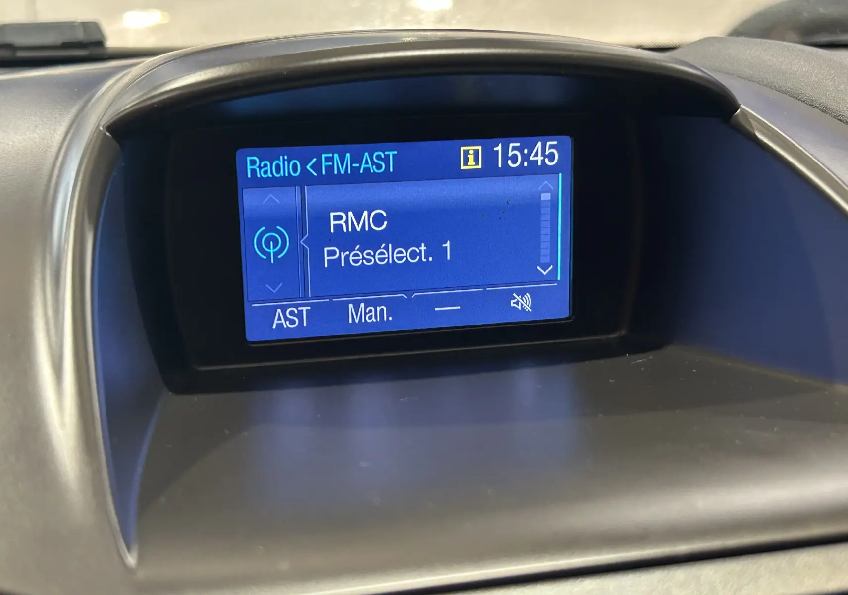 Écran central de la Ford Fiesta blanc 2015 affichant la radio FM avec la station RMC sélectionnée à 15h45.
