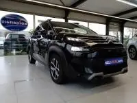 Vue 3/4 avant d'un Citroën C3 Aircross noir perla nera 2022 en showroom, avec jantes alliage et calandre distinctive.