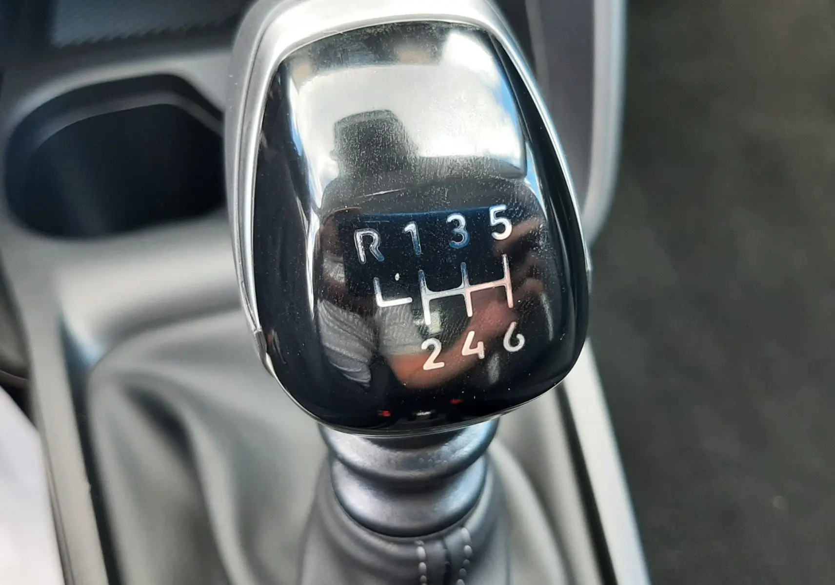 Gros plan sur le levier de vitesses manuel noir de la Citroën C3 Turbo 100ch Plus, avec marquage des six rapports et marche arrière.