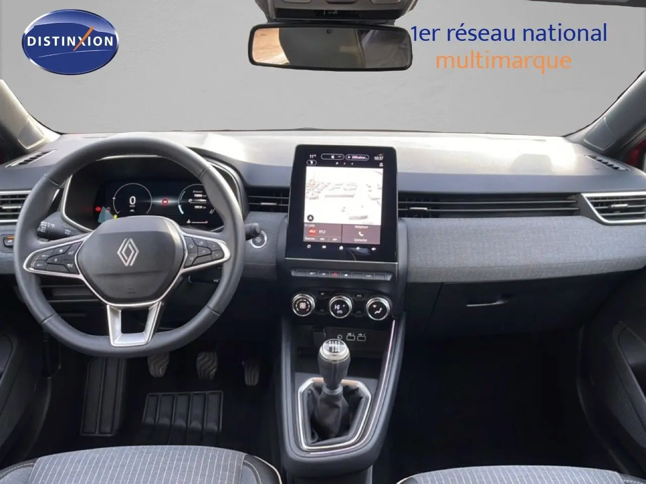 Vue intérieure avant de la Renault Clio rouge Désir Métal 2025, avec tableau de bord numérique et écran tactile central.