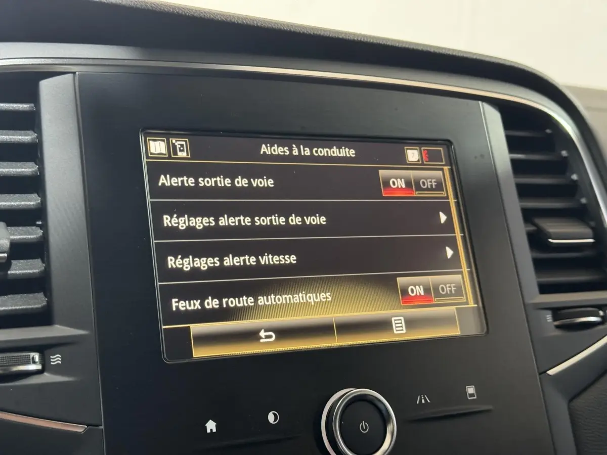 Écran tactile central de la Renault Mégane Business 2019 montrant les réglages d’aides à la conduite.