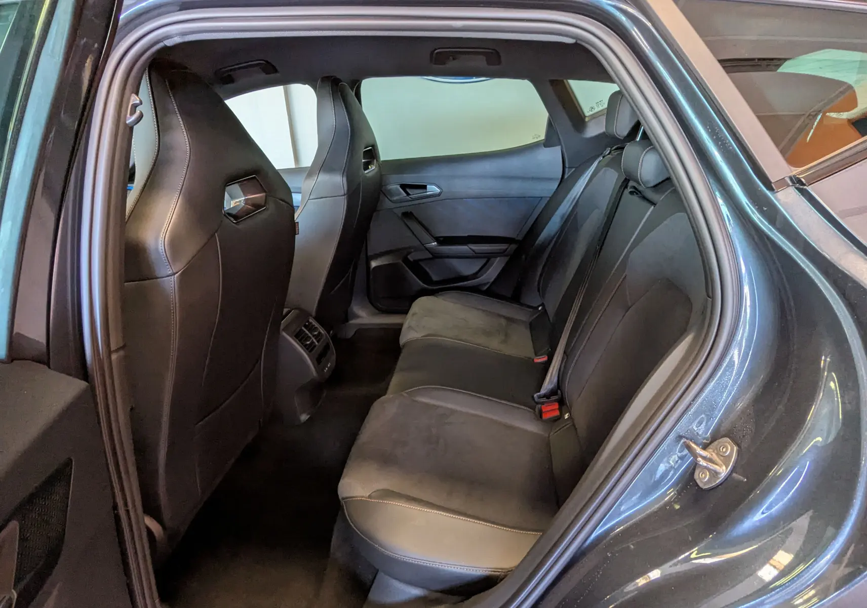 Vue intérieure côté gauche des sièges arrière en cuir et alcantara d'une CUPRA Formentor gris magnétique 2025.