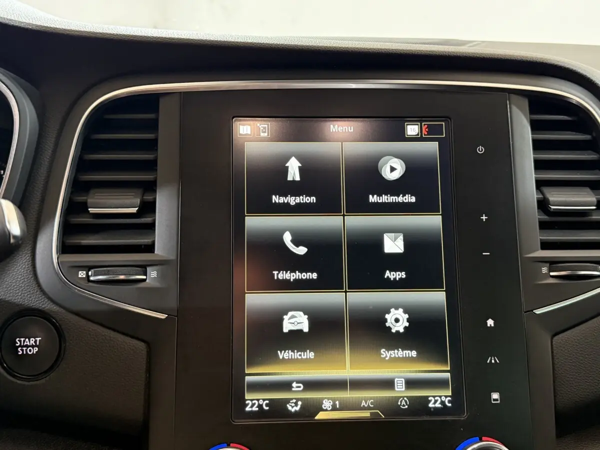 Écran tactile central de la Renault Mégane Intens gris foncé, avec menu multimédia et bouton Start/Stop visible à gauche.
