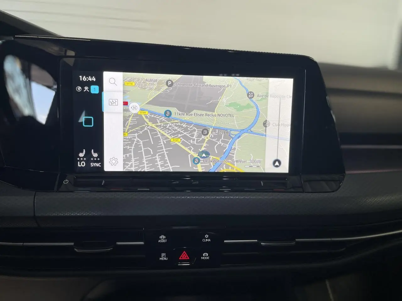 Écran tactile central affichant la navigation dans l'habitacle d'une Volkswagen Golf rouge métal 2022.