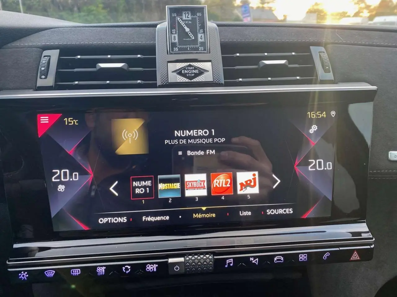 Tableau de bord du DS7 Crossback blanc 2022, vue frontale sur l'écran tactile et horloge analogique centrale.