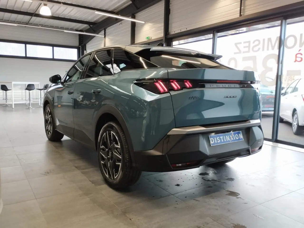 Vue 3/4 arrière droite du Peugeot 3008 hybride bleu Azul avec feux arrière LED à 3 griffes et jantes alliage 19 pouces.