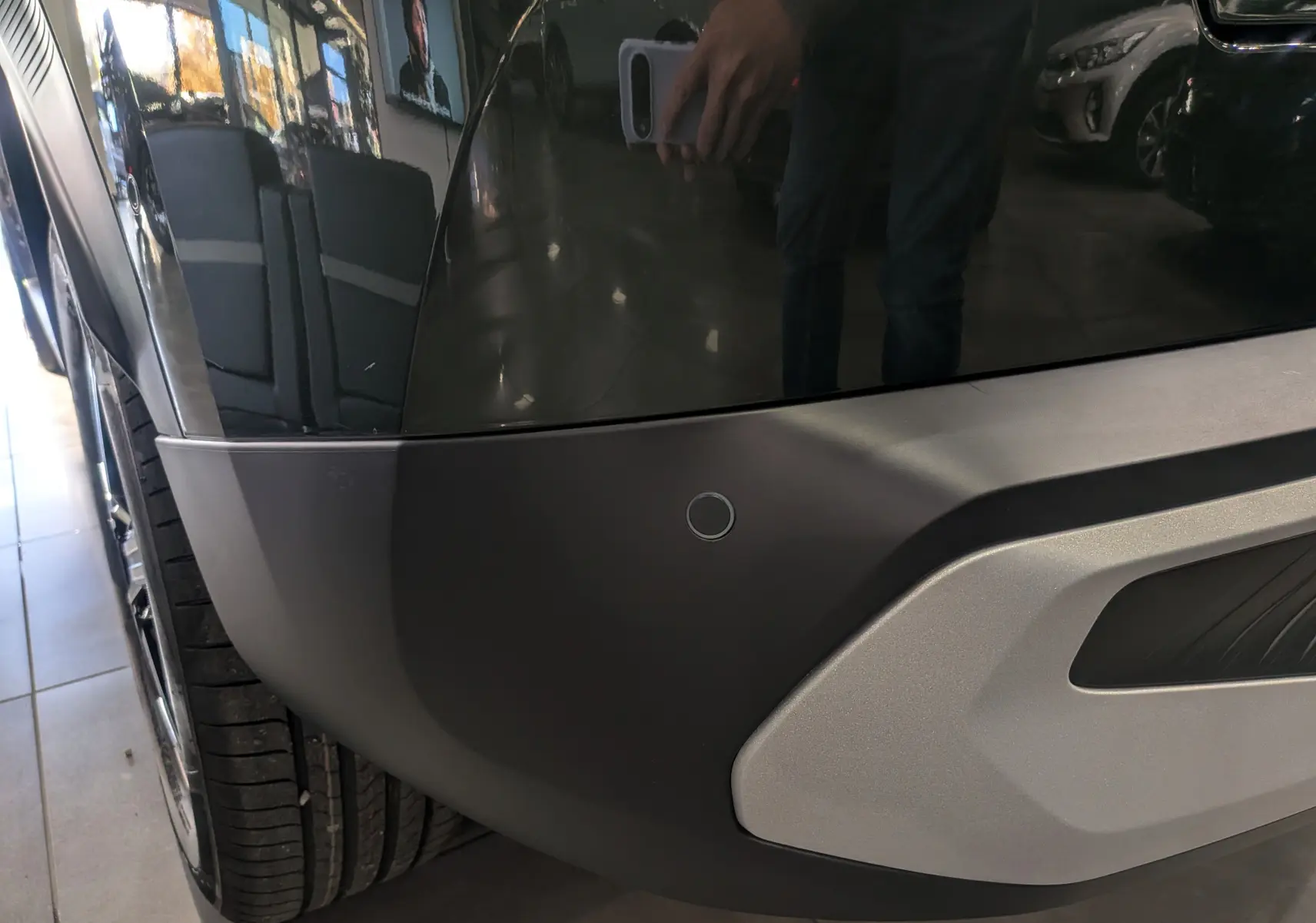 Gros plan sur le pare-chocs arrière gauche noir mat avec capteur de stationnement du Citroën C3 Aircross Vert Montana.