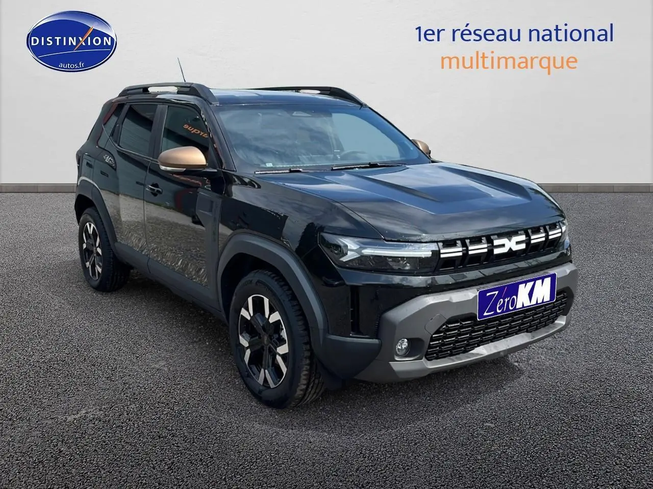 Vue 3/4 avant d'un Dacia Duster noir avec jantes alu et barres de toit sur fond neutre.