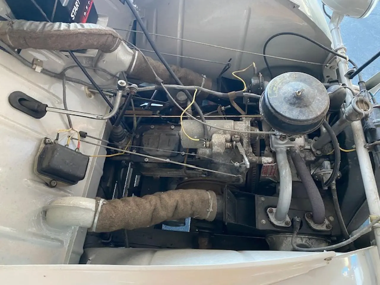 Moteur essence de la Citroën 2 CV beige clair de 1968, vue plongeante sur le compartiment moteur refait à neuf.