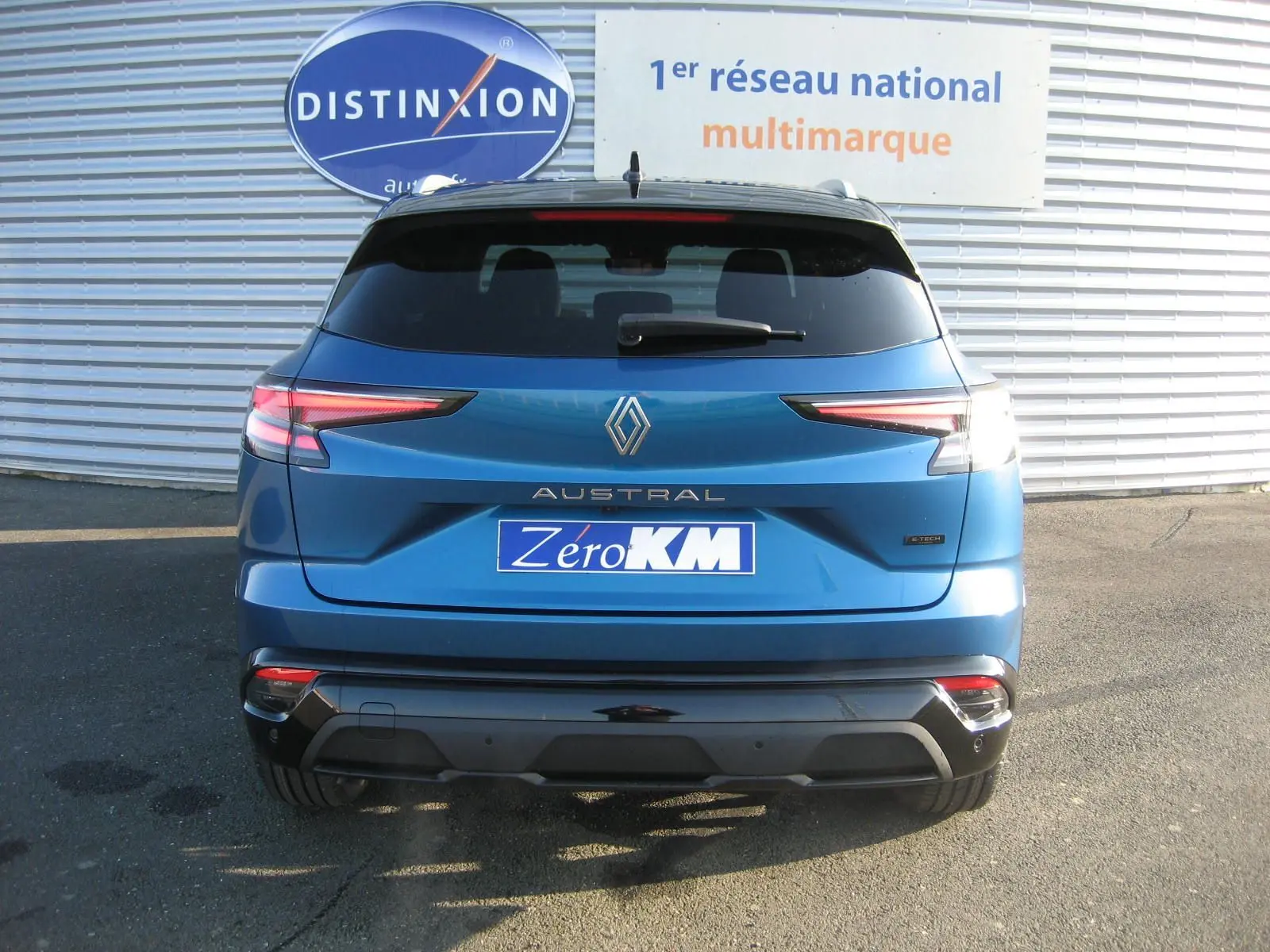 Vue arrière d'un Renault Austral bleu outremer avec toit noir, mettant en valeur ses feux LED et son badge E-Tech.