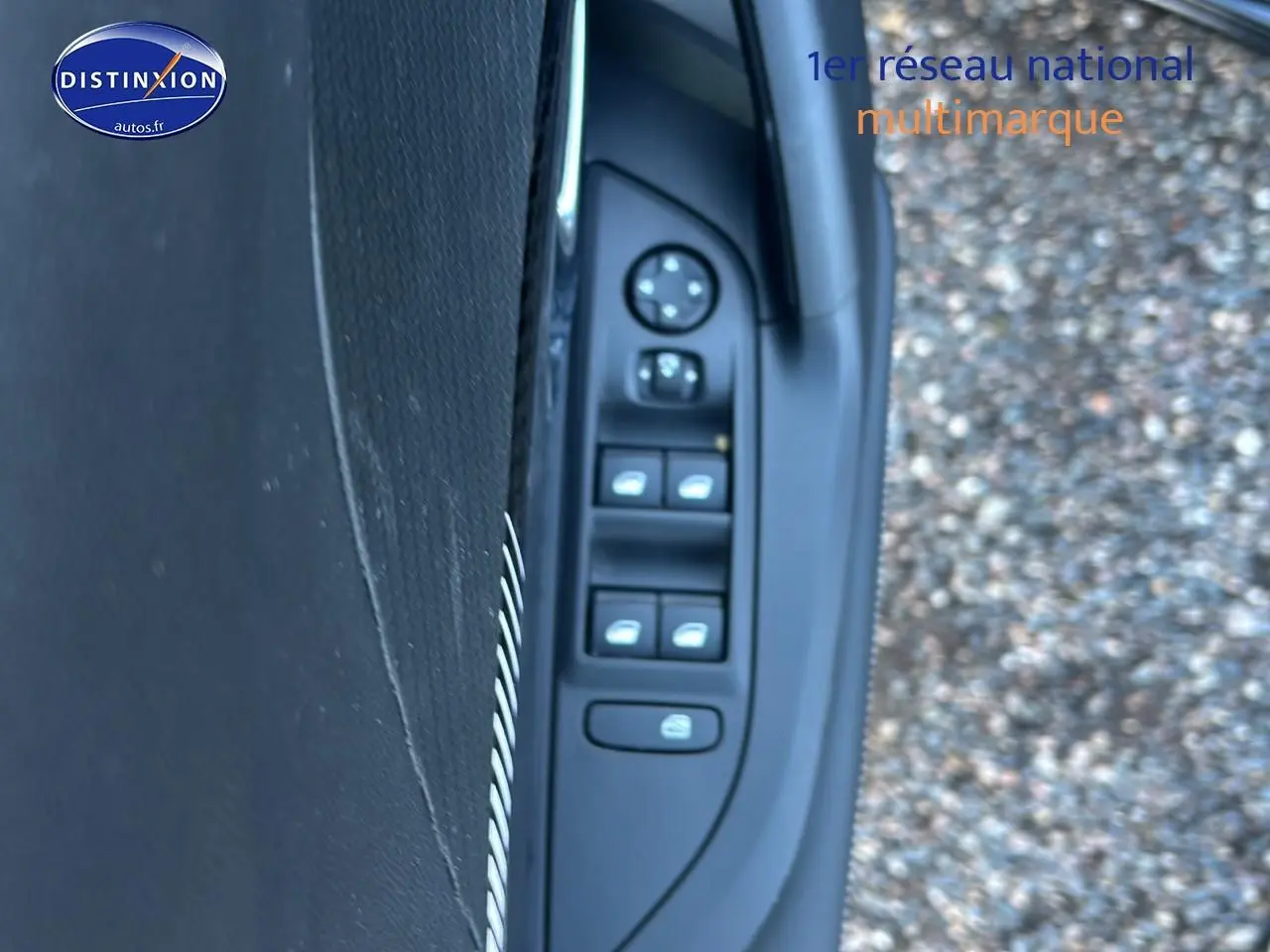 Vue rapprochée des commandes de vitres et rétroviseurs sur la porte côté conducteur d’un Peugeot 2008 noir.