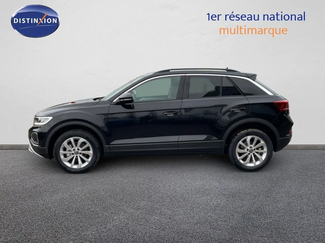 Profil côté gauche d'un Volkswagen T-Roc noir grenadilla métallisé, avec jantes alliage et toit ouvrant panoramique.