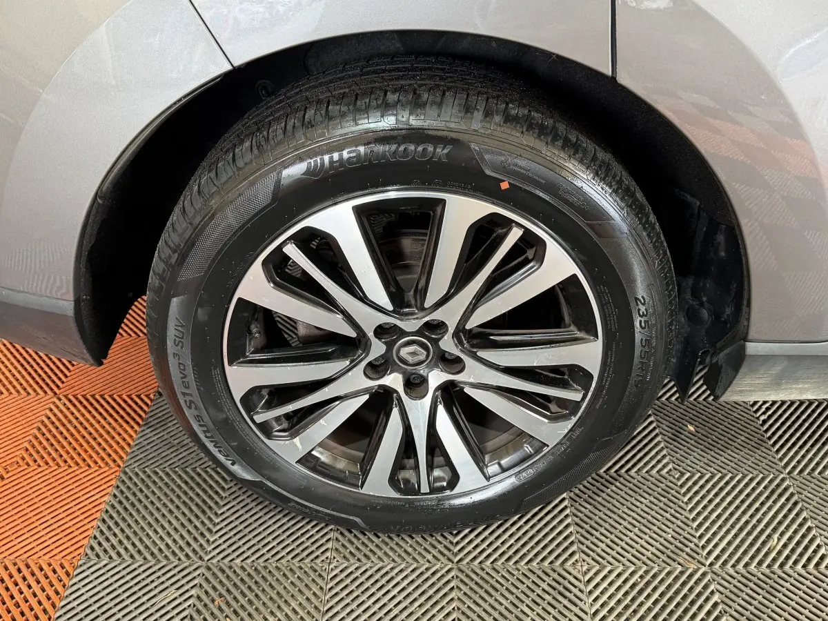 Gros plan sur la roue avant droite gris foncé d’un Renault Espace 2015 avec jante alliage distinctive.