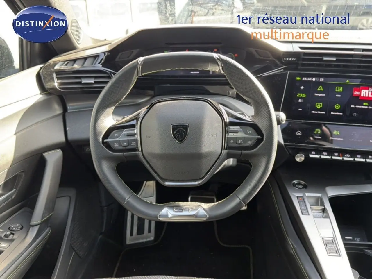 Vue intérieure centrée sur le volant GT en cuir noir et le tableau de bord numérique du Peugeot 408 gris Selenium Metal.