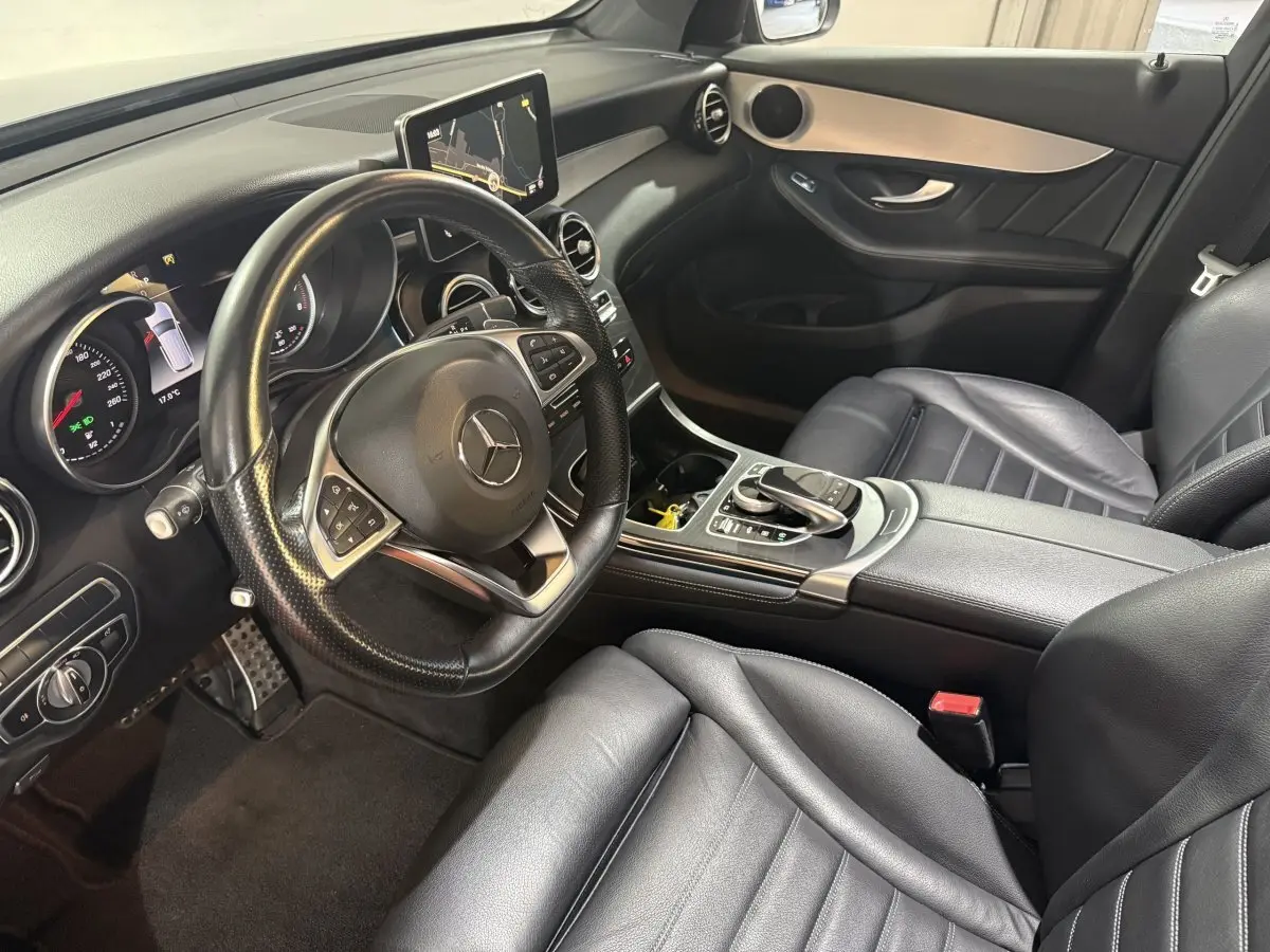 Vue intérieure côté conducteur du Mercedes GLC 250 Fascination 2019, avec sièges cuir noirs et tableau de bord moderne.