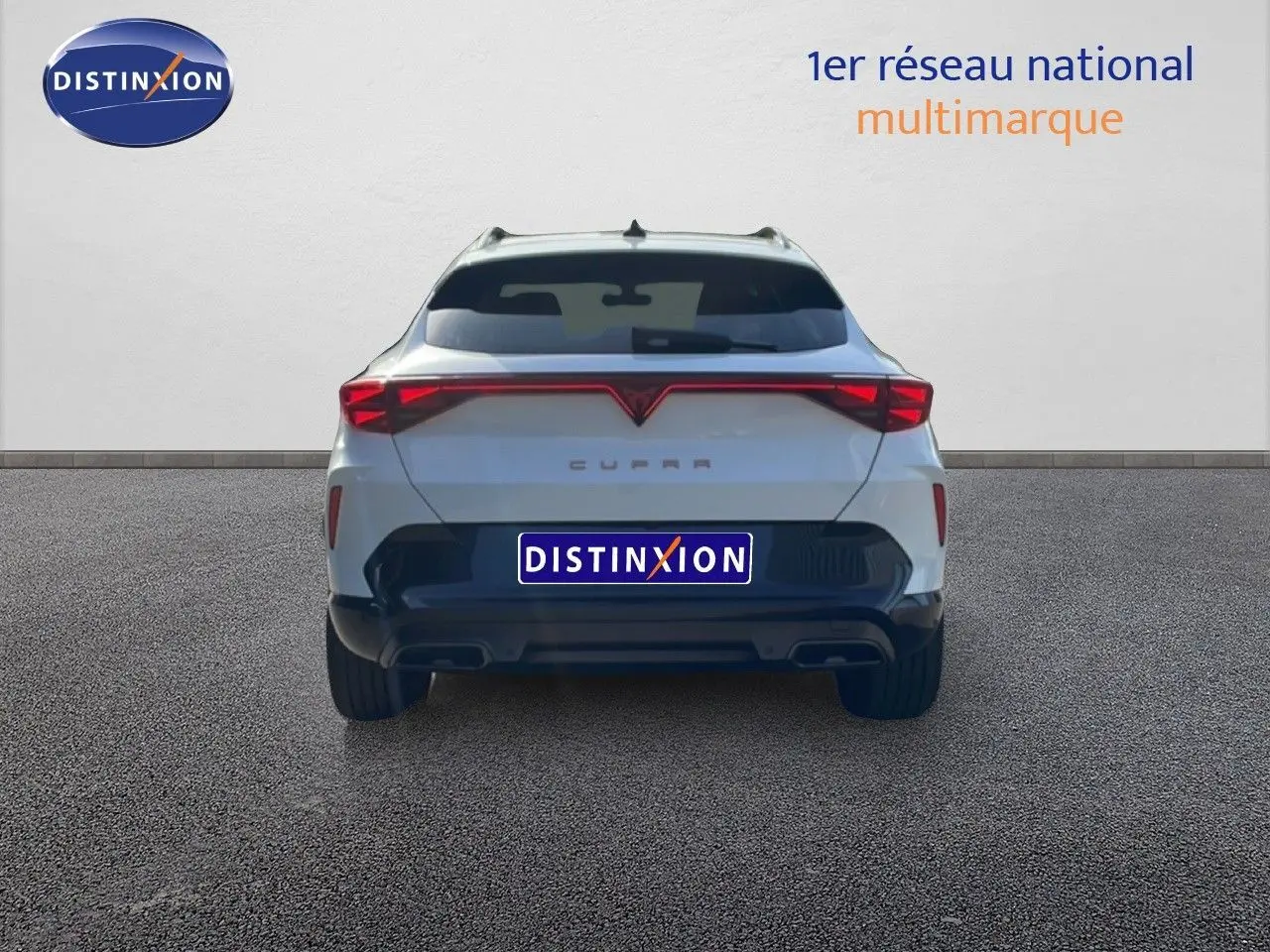 Vue arrière d'un CUPRA Formentor blanc neige métal 2025 avec feux LED reliés et double sortie d'échappement.