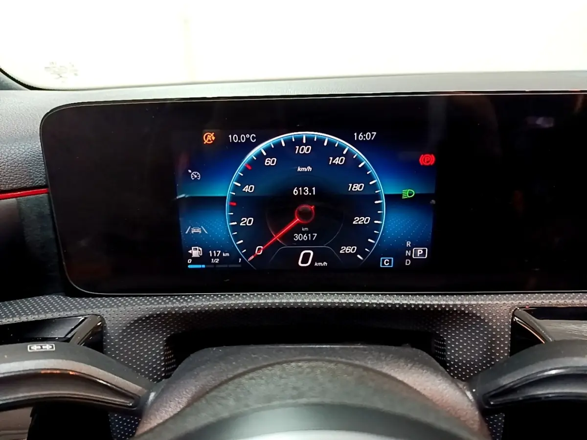 Tableau de bord numérique de la Mercedes Classe A 200 AMG Line 2021, affichage vitesse et informations à 16h07.