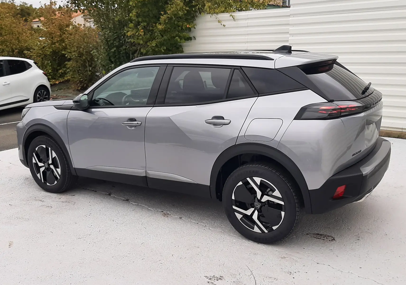 Peugeot 2008 gris Artense vue 3/4 arrière droit avec toit noir et jantes bi-ton modernes.