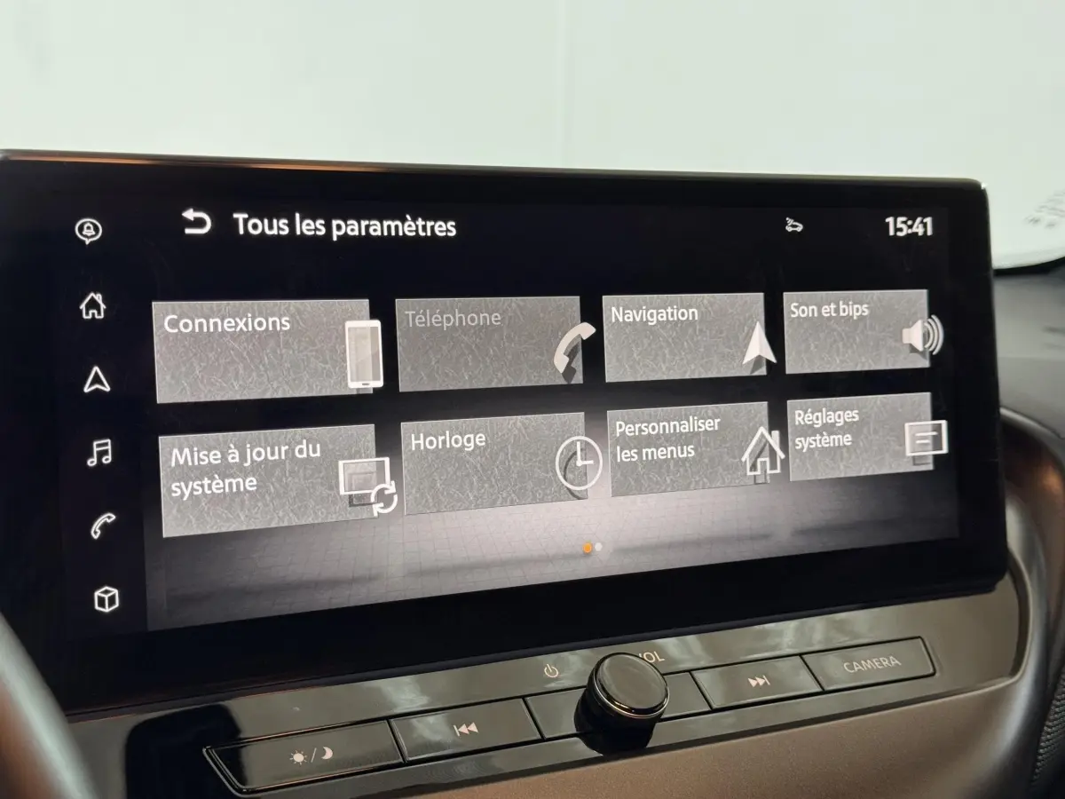 Gros plan sur l’écran tactile central du Nissan Juke gris clair 2025, affichant le menu des paramètres.