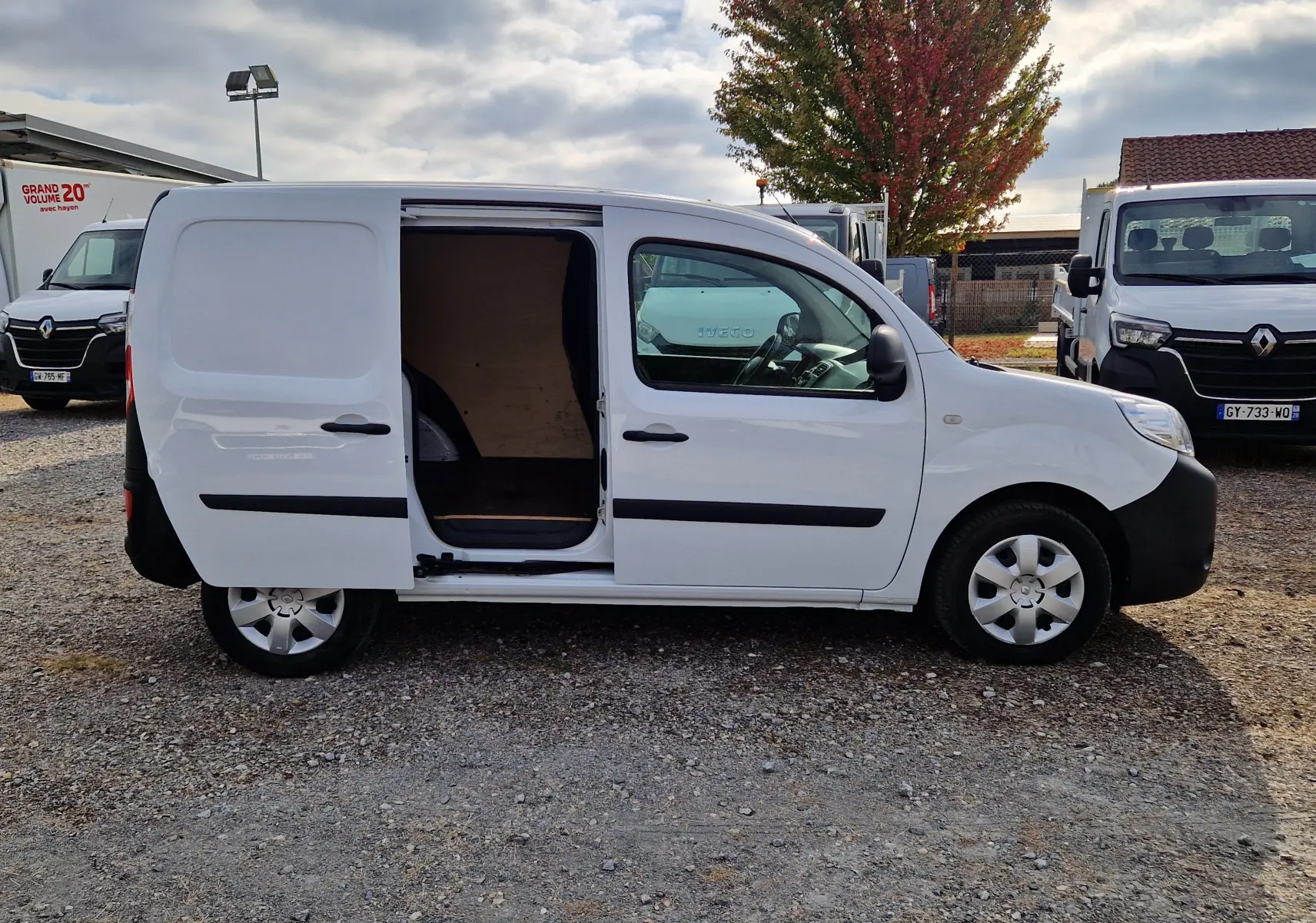 Renault Kangoo blanc 2021 vue de profil droit avec porte coulissante ouverte montrant l’espace de chargement vide.