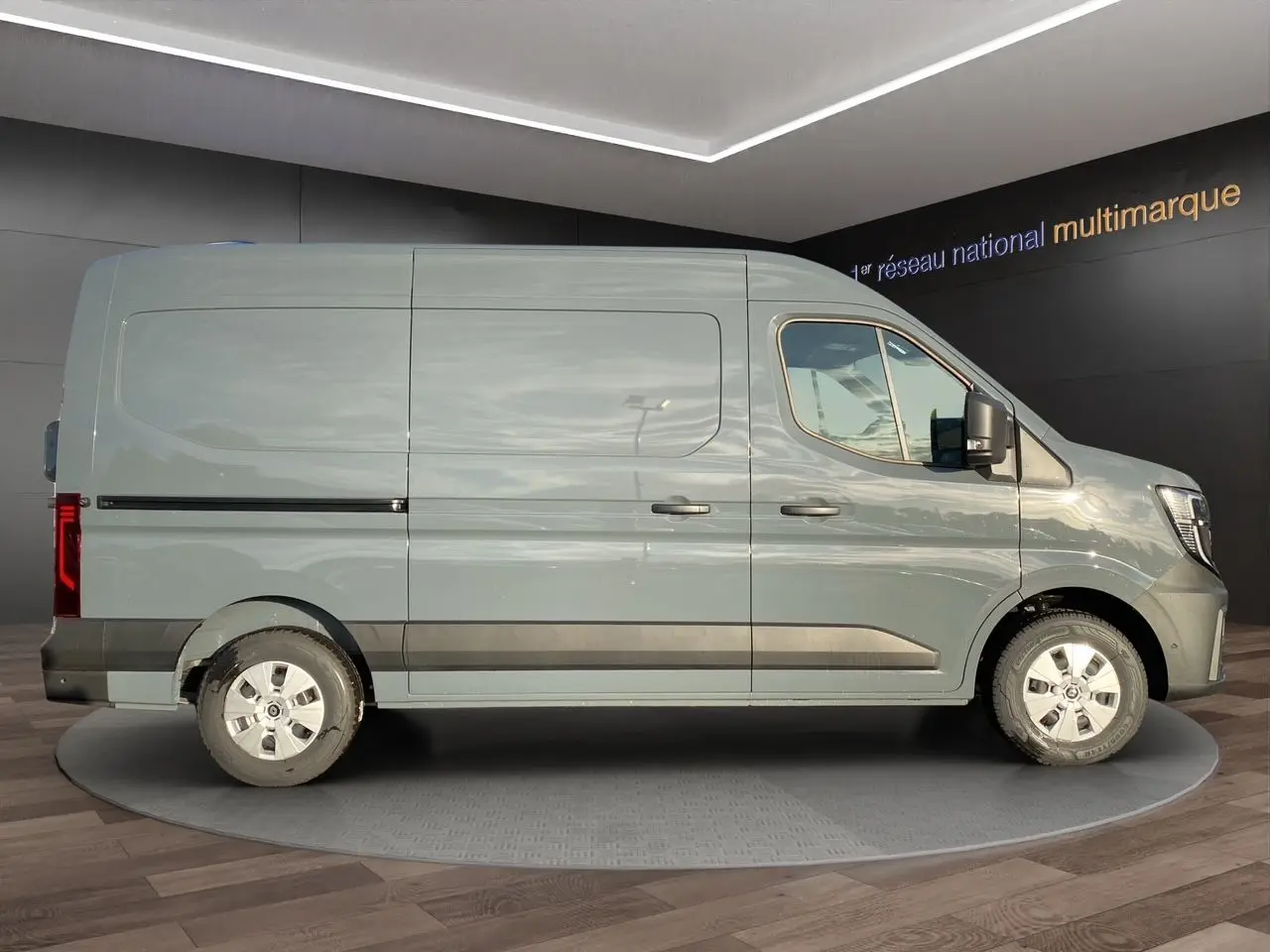 Vue de profil côté gauche d’un Renault Master 2025 gris urbain avec portes latérales et bas de caisse noirs.