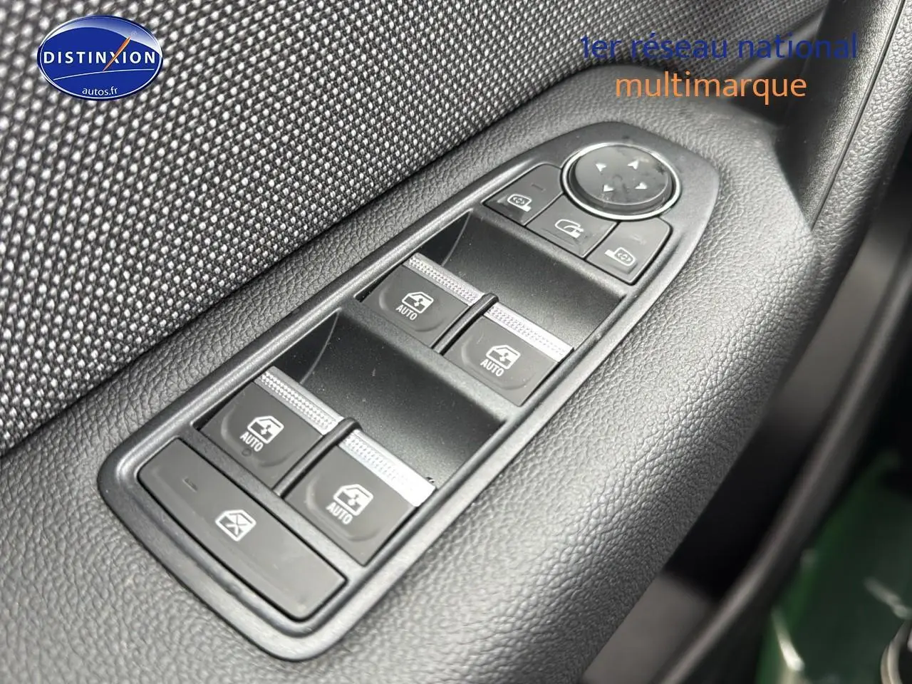 Gros plan sur les commandes des vitres électriques côté conducteur du Renault Captur gris cassiopée 2025.