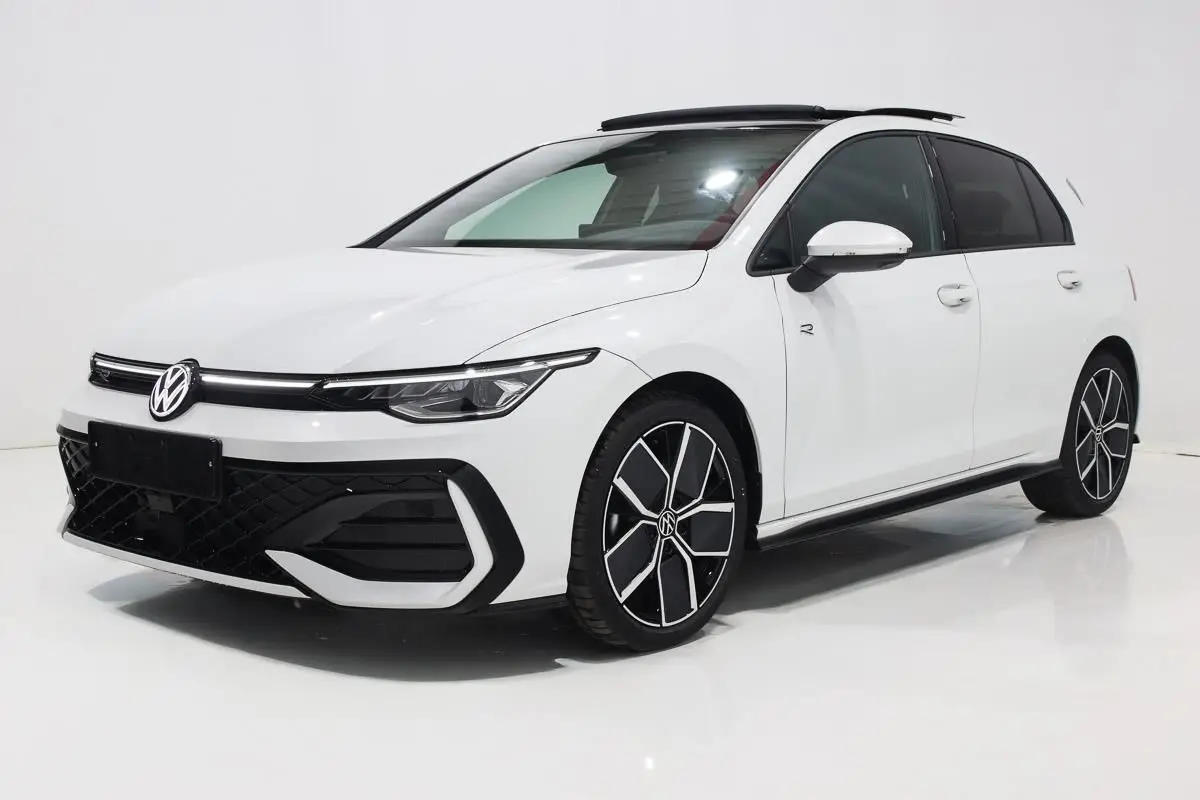 Vue 3/4 avant droite d'une Volkswagen Golf 2.0 TDI blanche avec toit panoramique et jantes alliage 18 pouces.