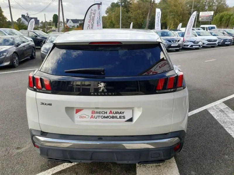 Vue arrière d'un Peugeot 3008 blanc nacré avec feux arrière à griffes et lunette arrière teintée.
